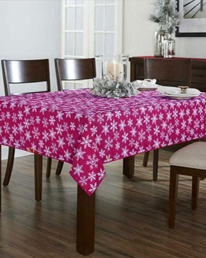Burgundy Festive Holiday Snowflake Peva Table Cloth over a wooden Table