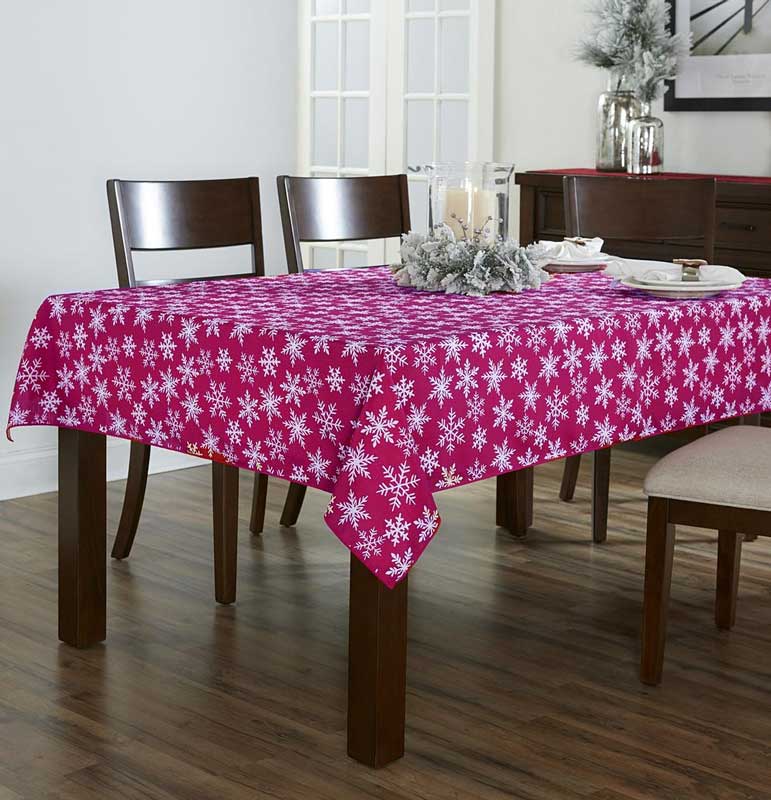 Burgundy Festive Holiday Snowflake Peva Table Cloth over a wooden Table