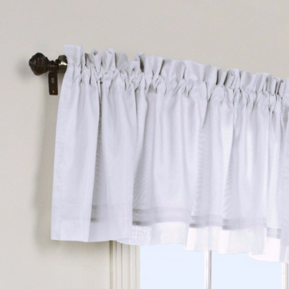 Closeup of White Rhapsody Lined Tailored Valance hanging on a curtain rod